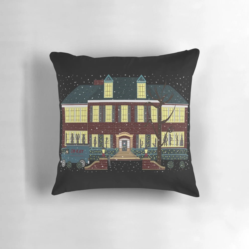 Pillow featuring the iconic home from the movie Home Alone with shadows dancing in the snowy window