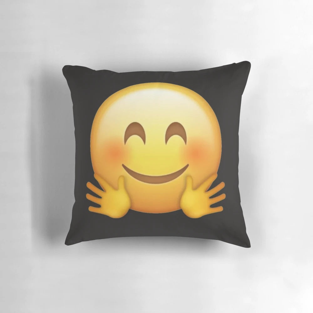 A soft, yellow pillow in the shape of a hugging emoji face, perfect for snuggling and expressing love.