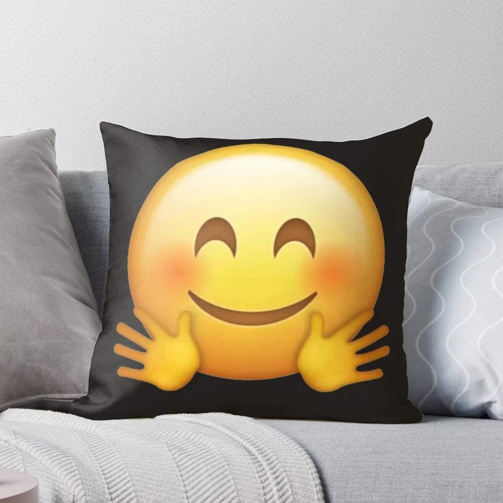 A soft, yellow pillow in the shape of a hugging emoji face, perfect for snuggling and expressing love.