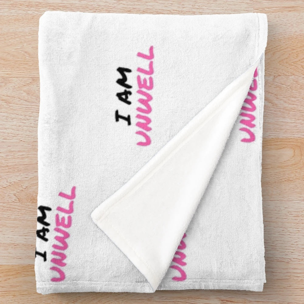 I Am Unwell" plush blanket, featuring a soft and cozy design