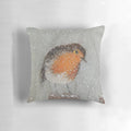 A soft, plush pillow featuring a cute robin bird and snowy winter scene