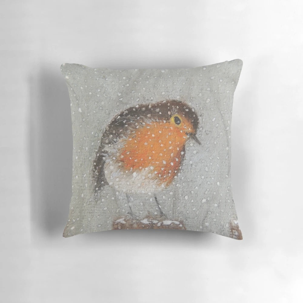 A soft, plush pillow featuring a cute robin bird and snowy winter scene