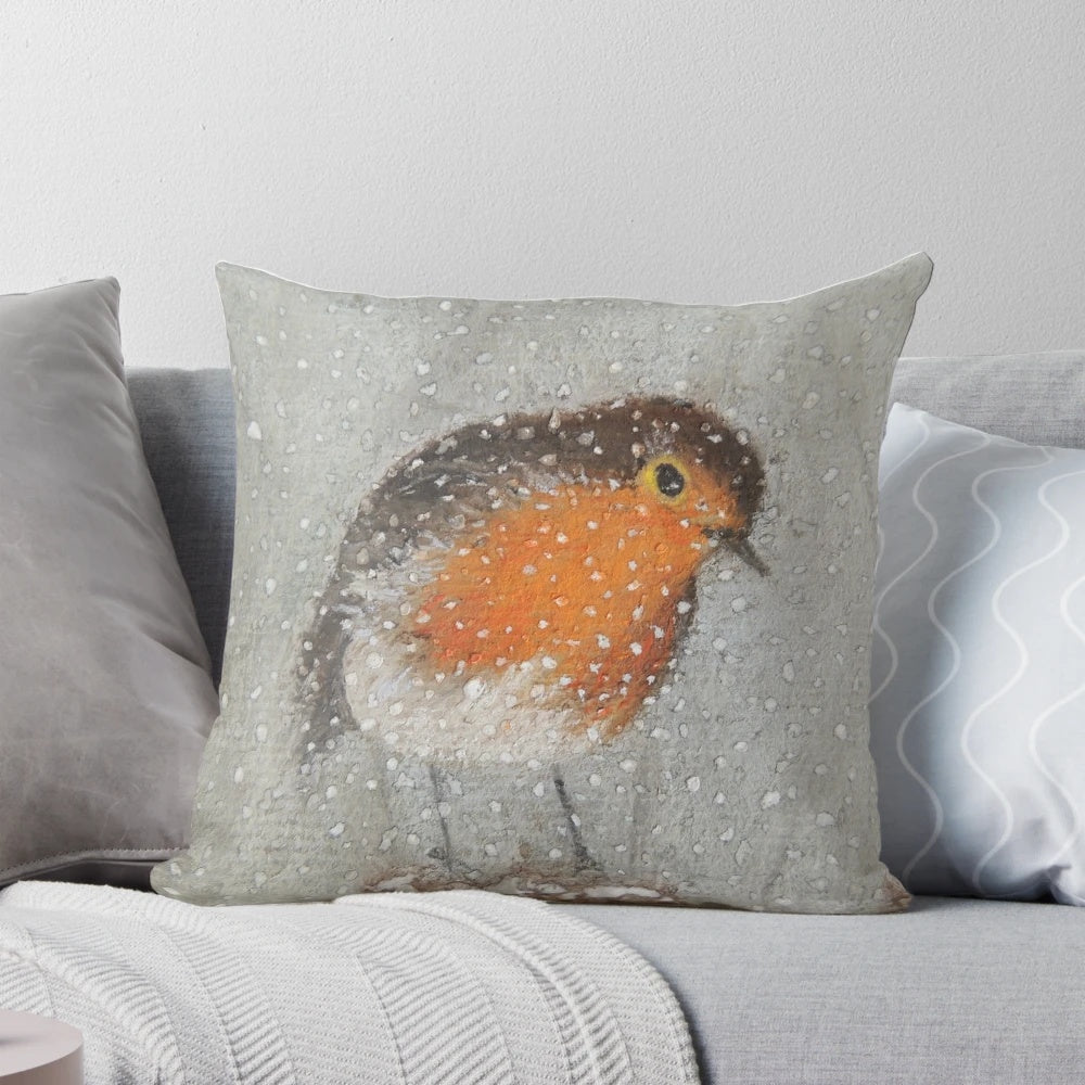 A soft, plush pillow featuring a cute robin bird and snowy winter scene