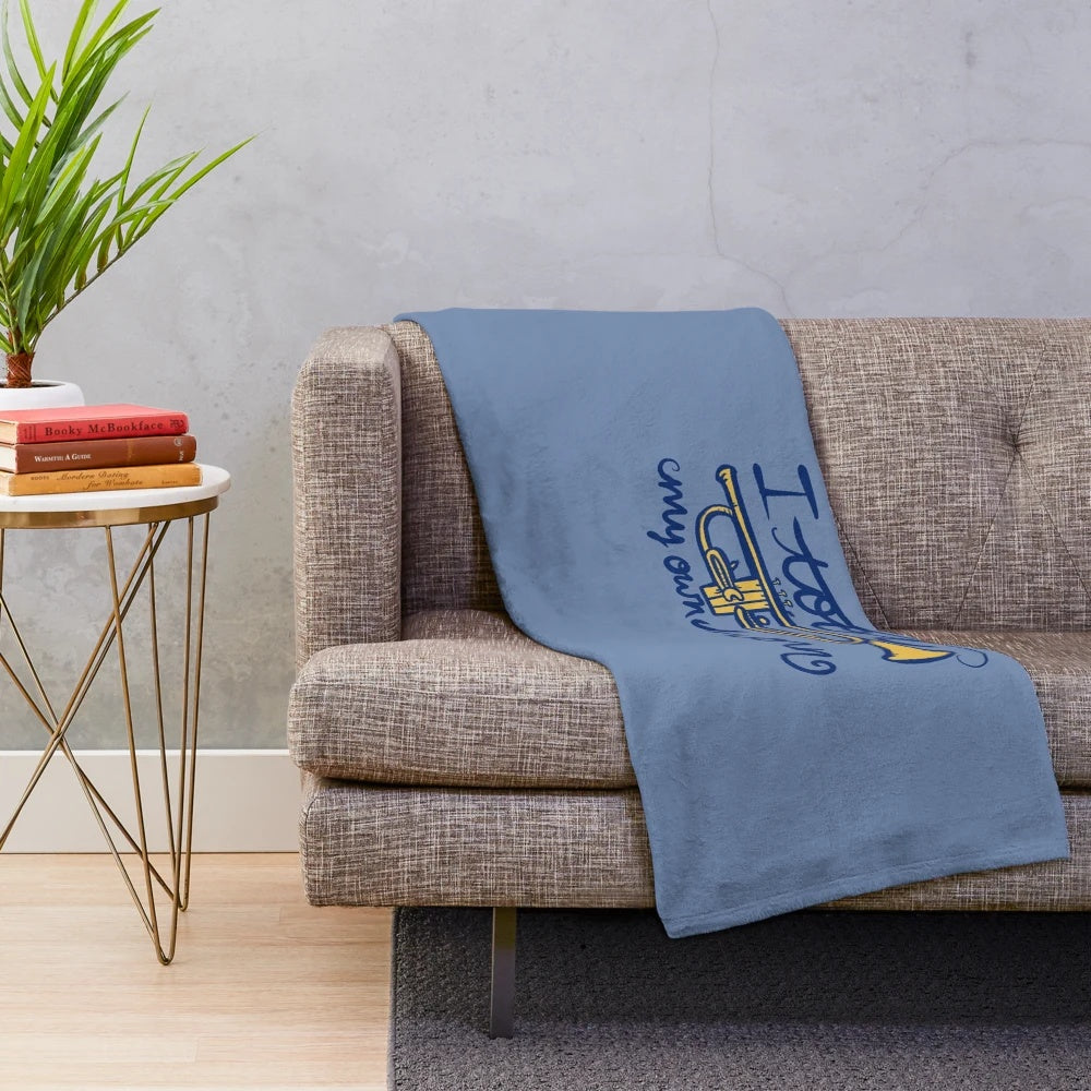 I Toot My Own Horn' plush blanket featuring a trumpet and musical notes