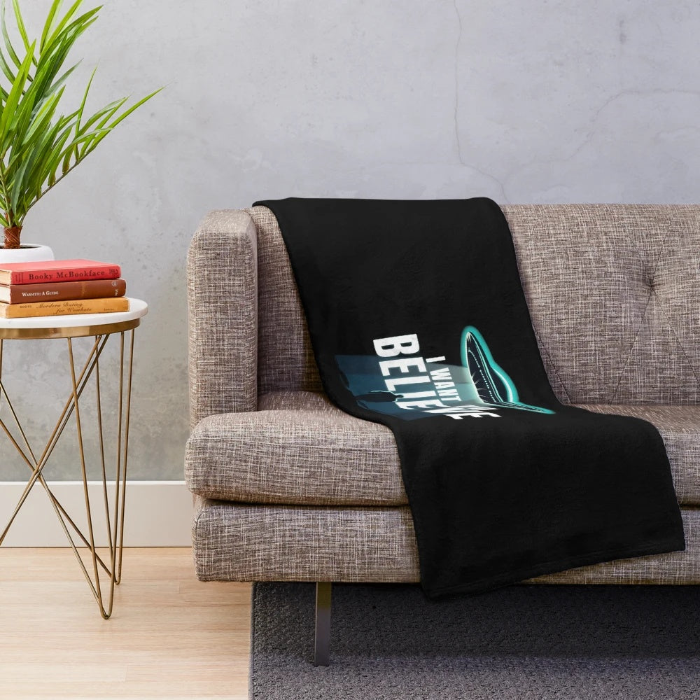 Soft and plush "I Want to Believe" themed blanket with UFO and alien graphics