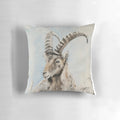 Soft pillow featuring an illustration of an ibex mountain goat with curved horns against a snowy mountain backdrop.