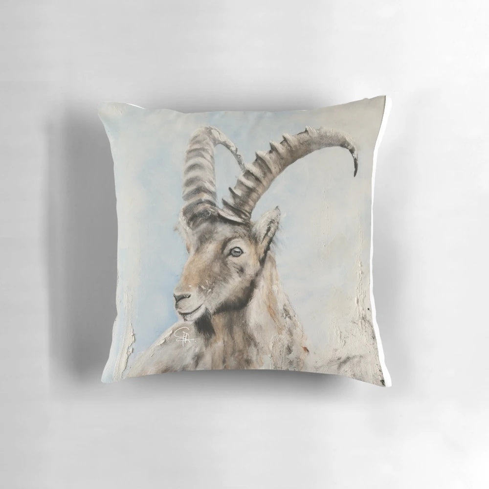 Soft pillow featuring an illustration of an ibex mountain goat with curved horns against a snowy mountain backdrop.