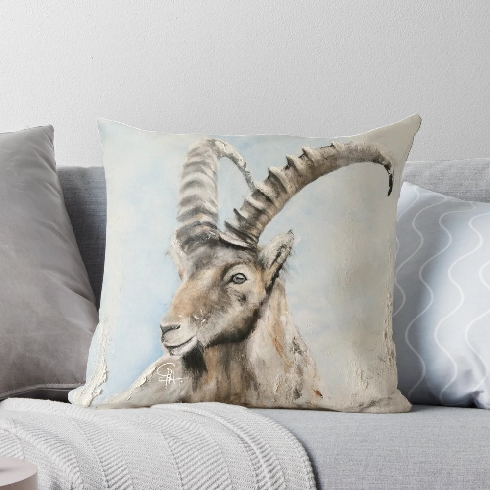 Soft pillow featuring an illustration of an ibex mountain goat with curved horns against a snowy mountain backdrop.