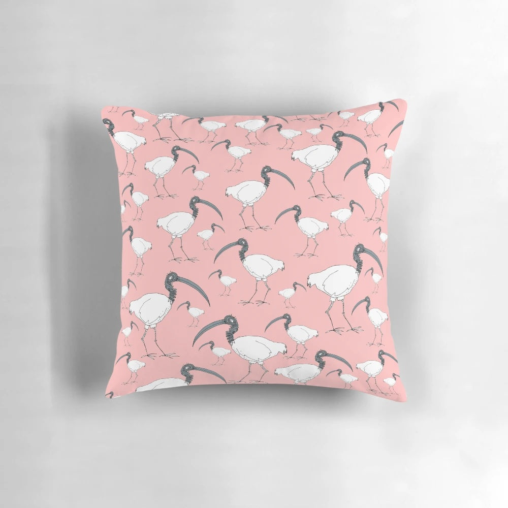 Soft, plush pillow featuring a flock of playful ibises in a rustic wooden bin