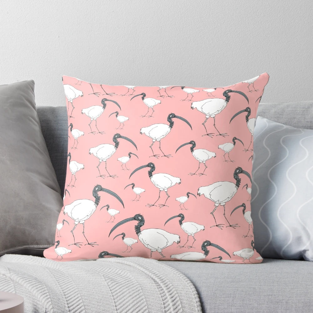 Soft, plush pillow featuring a flock of playful ibises in a rustic wooden bin