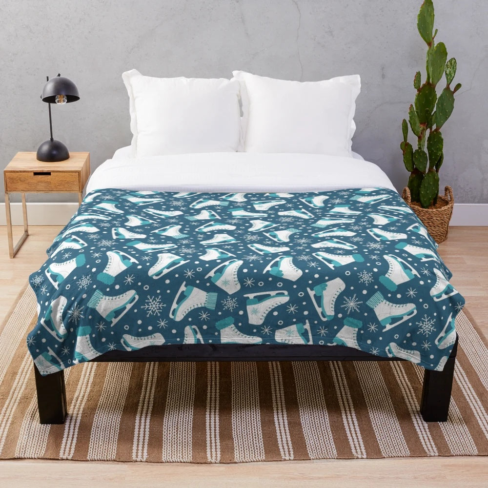 Plush blanket featuring ice skates and snowflakes design