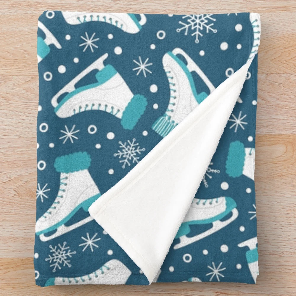 Plush blanket featuring ice skates and snowflakes design