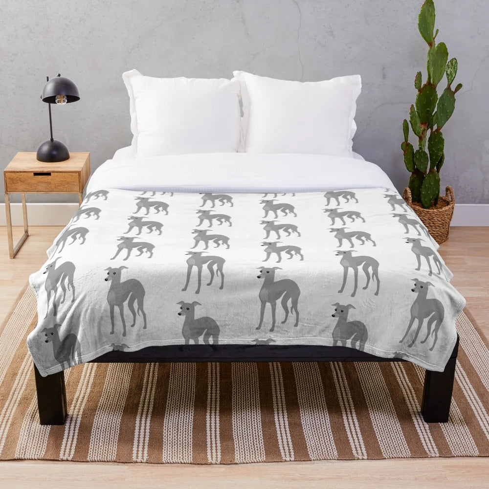 Italian Greyhound or Whippet dog on a plush grey blanket