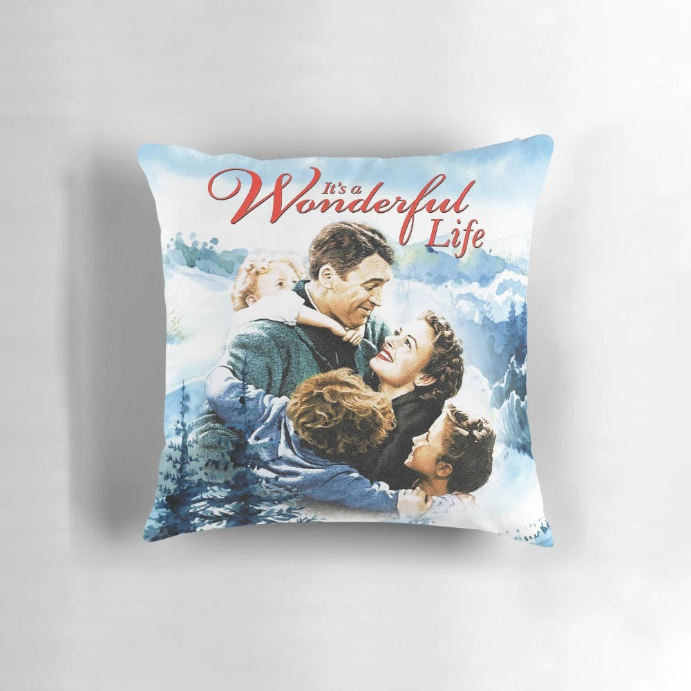 A vintage-inspired pillow featuring a snowy landscape scene from the classic film "It's a Wonderful Life"