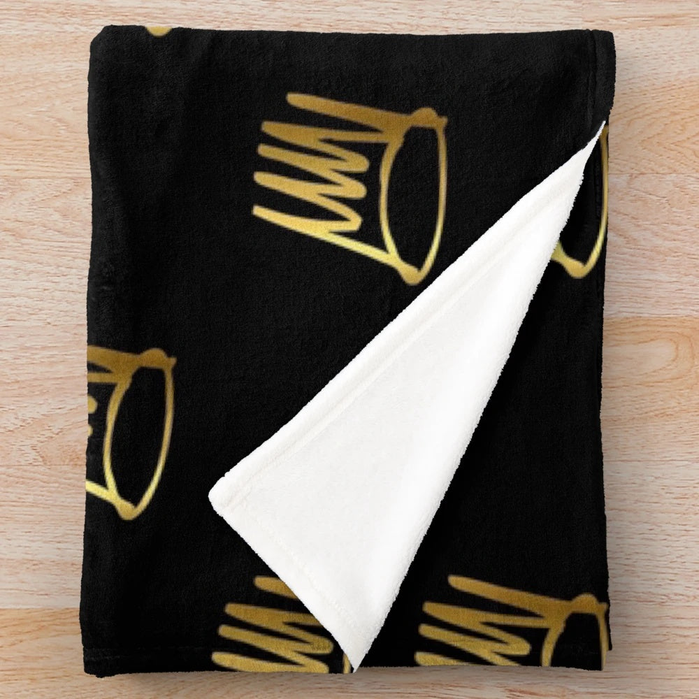 Soft and plush blanket featuring the j cole gold crown design