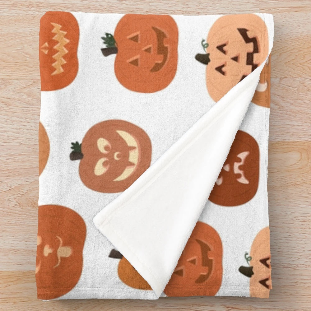 Plush blanket featuring a pattern of cute jack o' lanterns