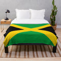 Plush blanket featuring the vibrant colors and design of the Jamaican national flag