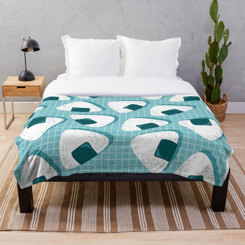 Soft and cuddly plush blanket with a Japanese onigiri food pattern design