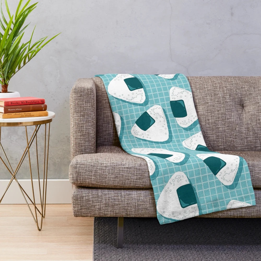 Soft and cuddly plush blanket with a Japanese onigiri food pattern design