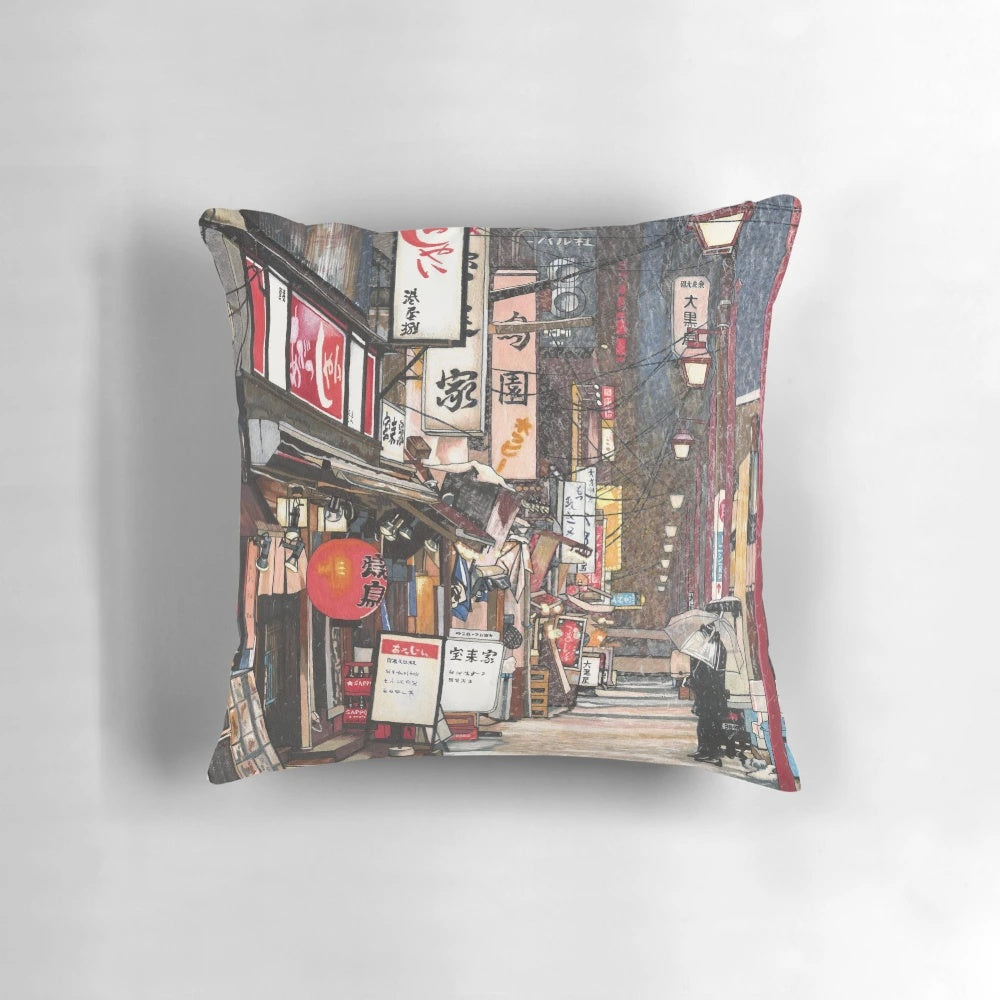A plush pillow featuring a snowy Japanese city scene with red lanterns and lights against a night sky.