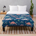 Jurassic dinosaur plush blanket in blue and coral colors