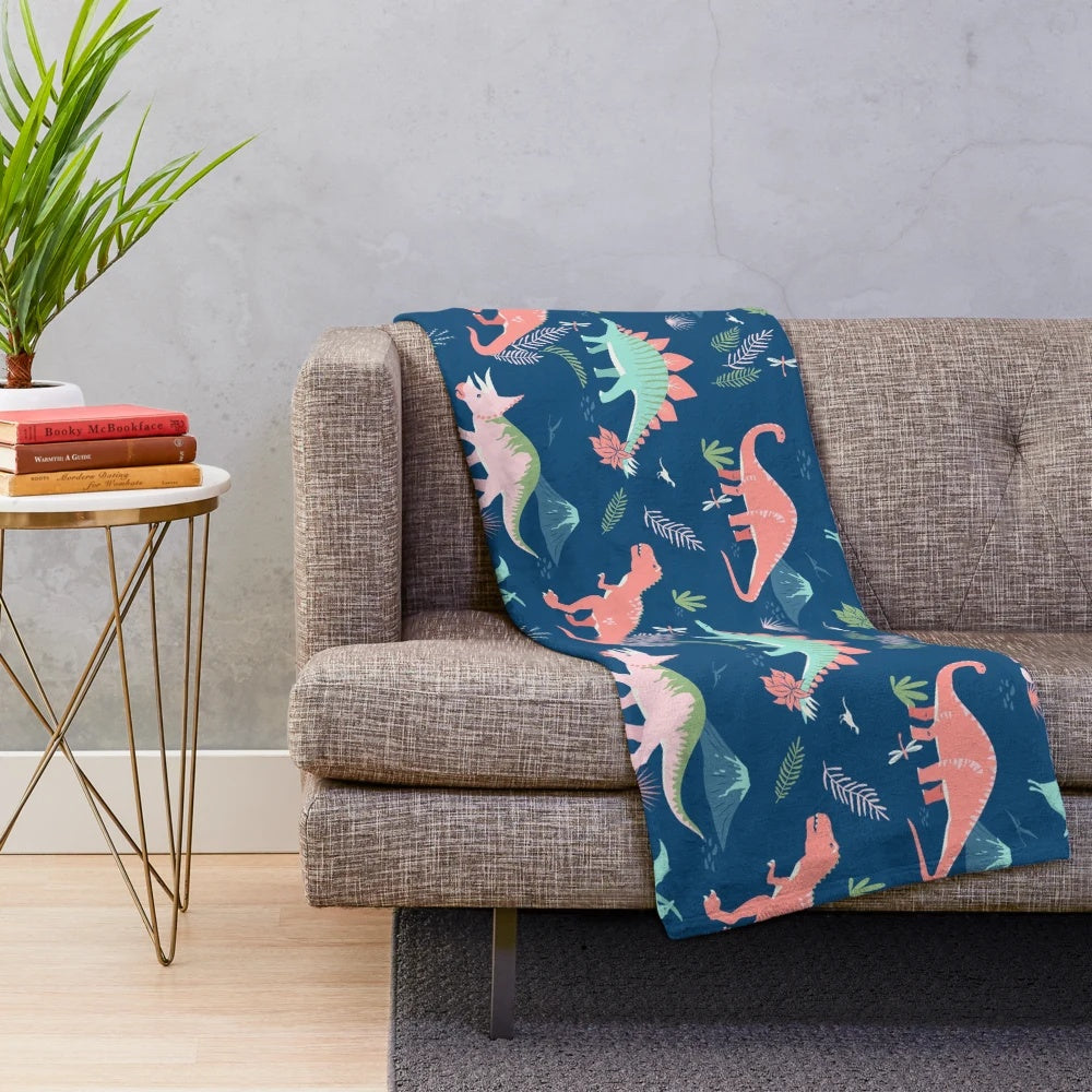 Jurassic dinosaur plush blanket in blue and coral colors