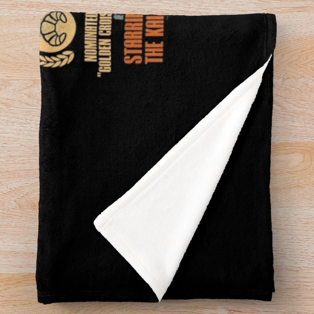 Plush blanket featuring a kaiju-inspired croissant design