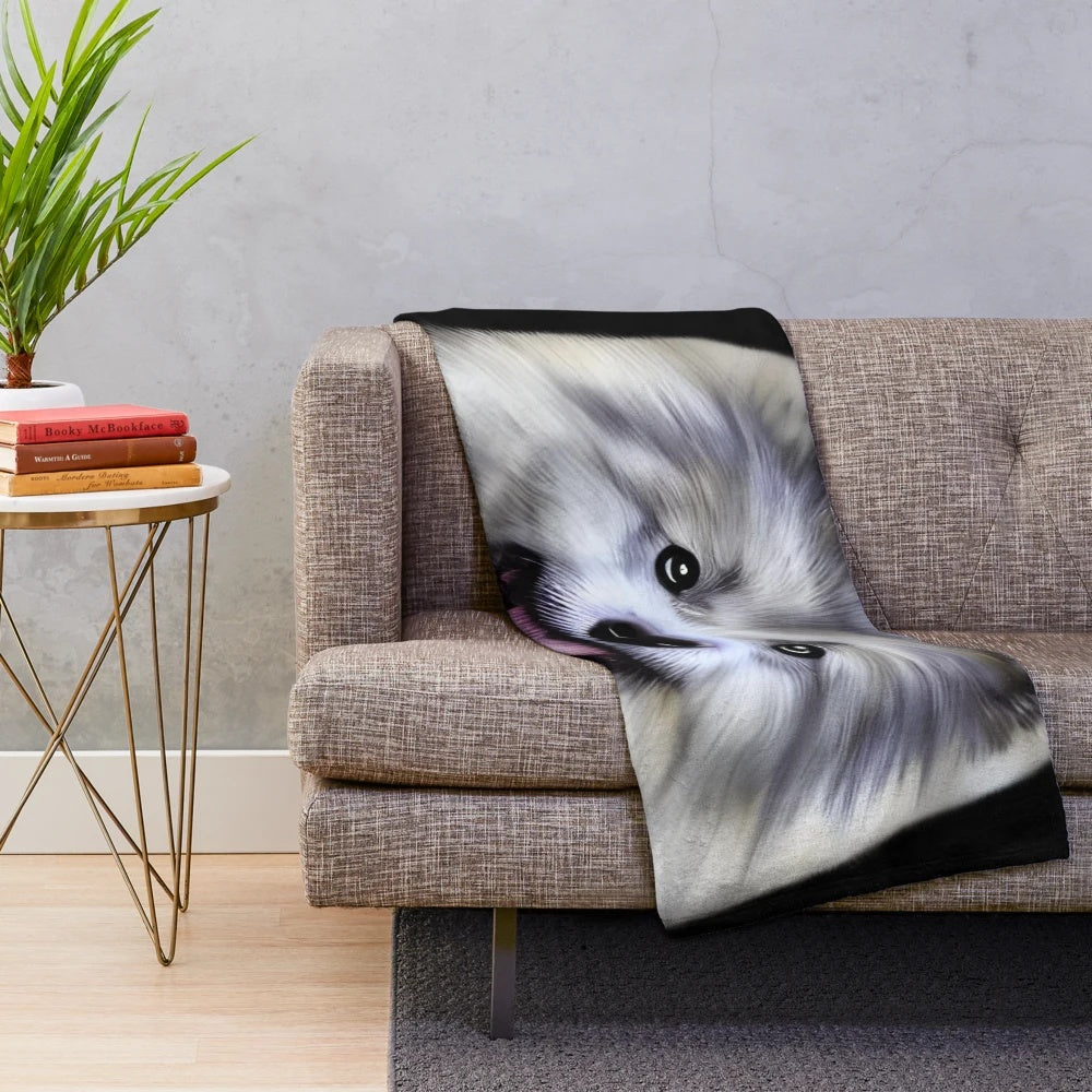 Cute Keeshond dog on a soft, plush blanket