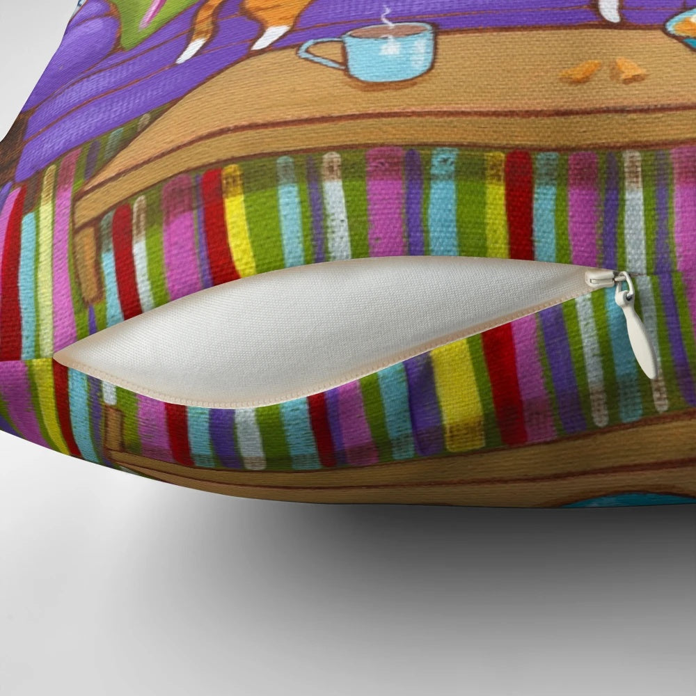 Knitted cats pillow in a cottage core style, featuring orange and tuxedo cats napping on a couch