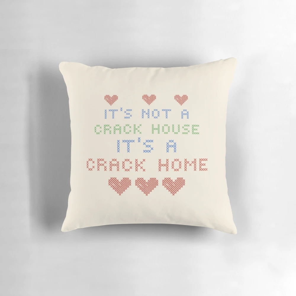 Knitted pillow with "It's Not a Crack House, It's a Crack Home" text