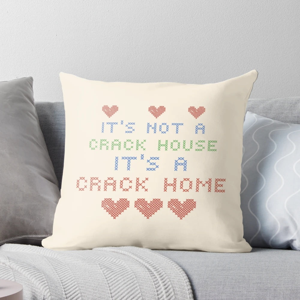 Knitted pillow with "It's Not a Crack House, It's a Crack Home" text