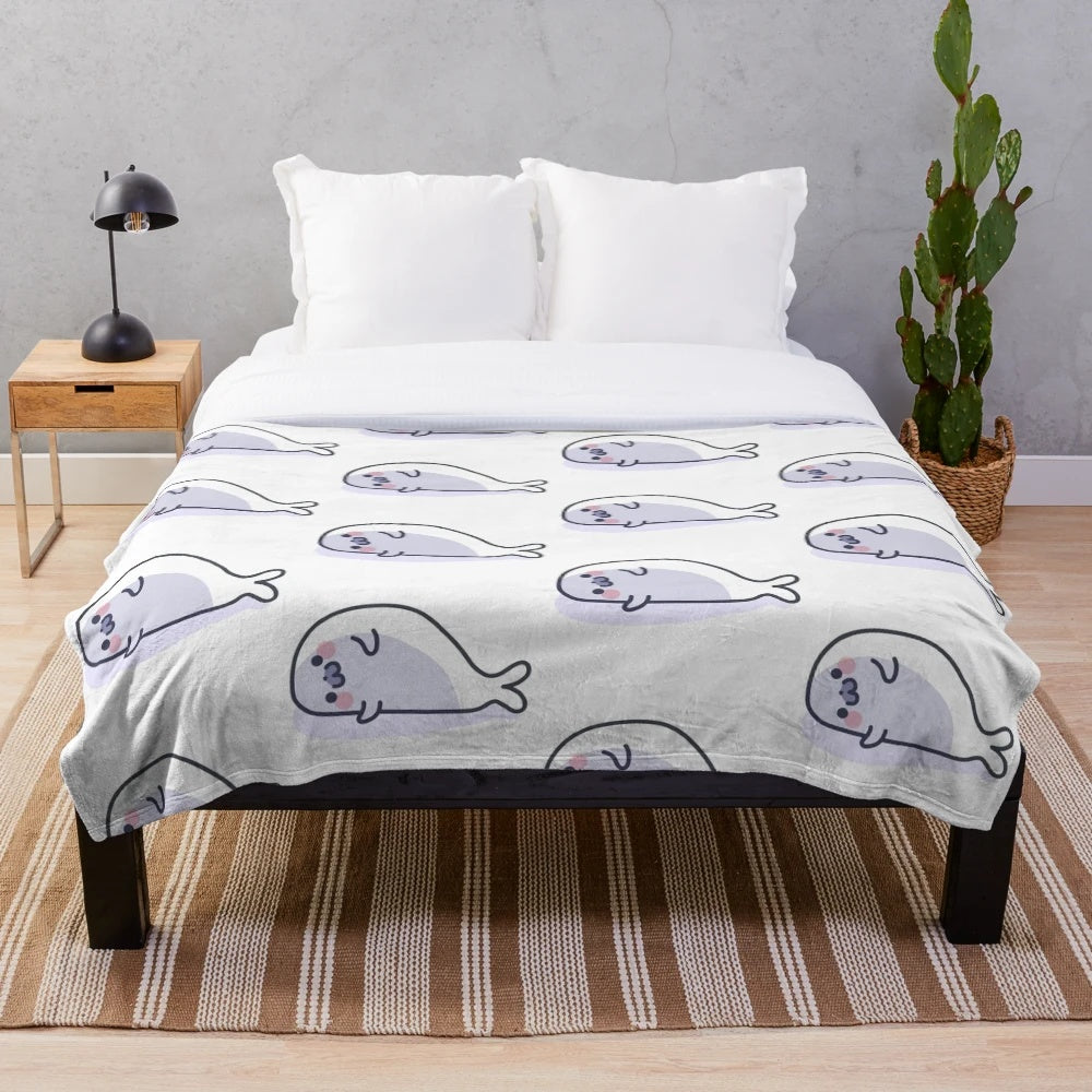 Soft and cuddly plush blanket featuring a lazy, cute seal design