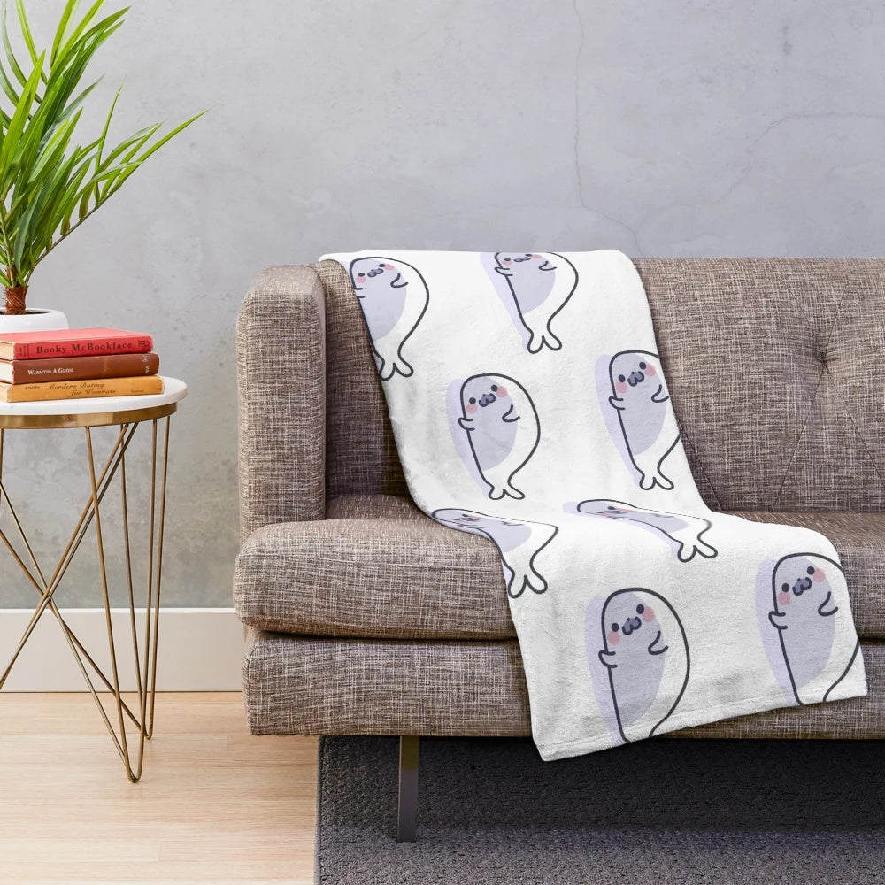 Soft and cuddly plush blanket featuring a lazy, cute seal design