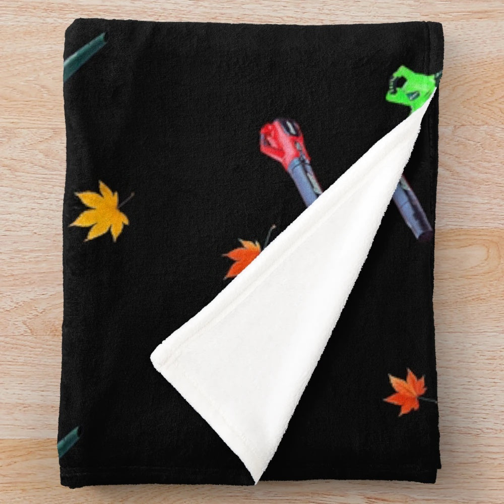 Plush blanket with leaf blower pattern design in autumn colors