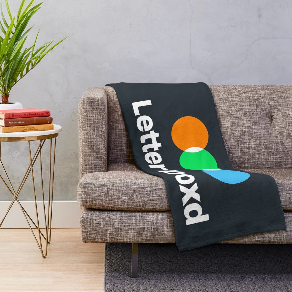 Soft, black and white plush blanket featuring the Letterboxd logo for movie fans and cinephiles