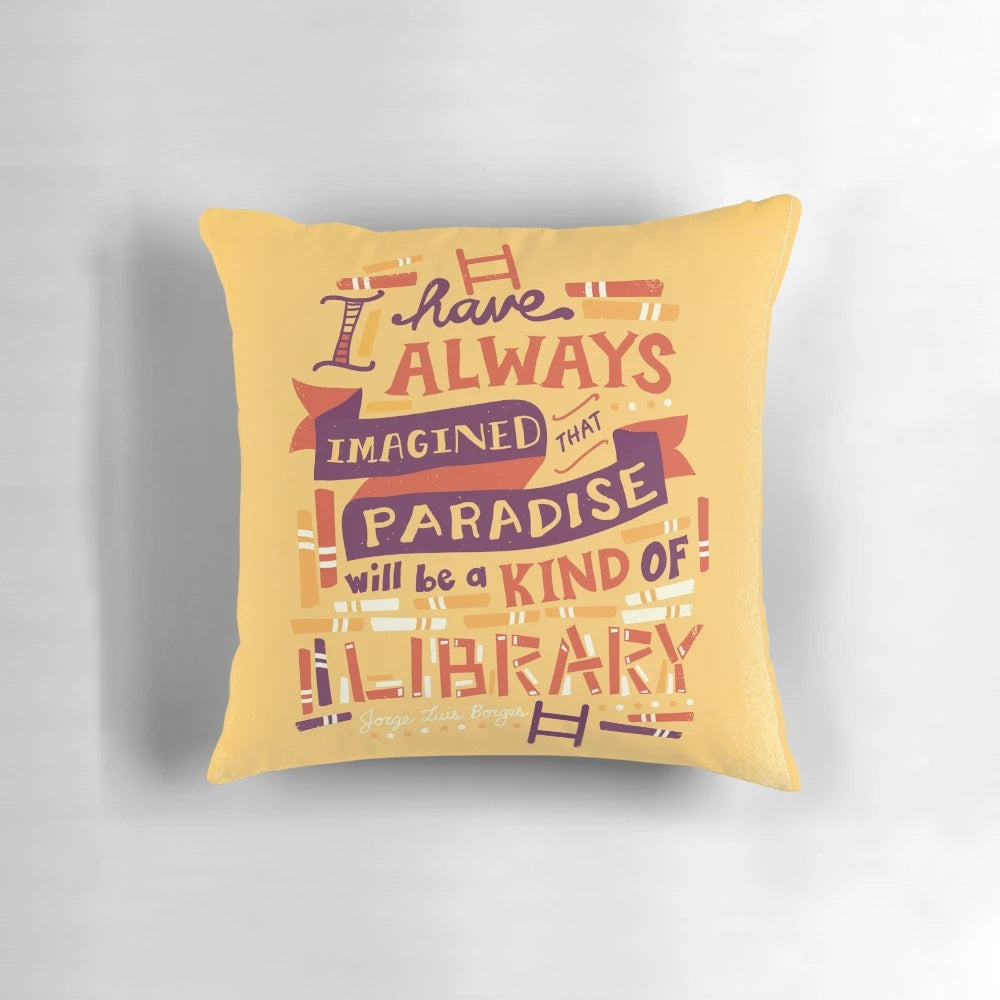 Soft, hand-lettered library pillow with open books and typography