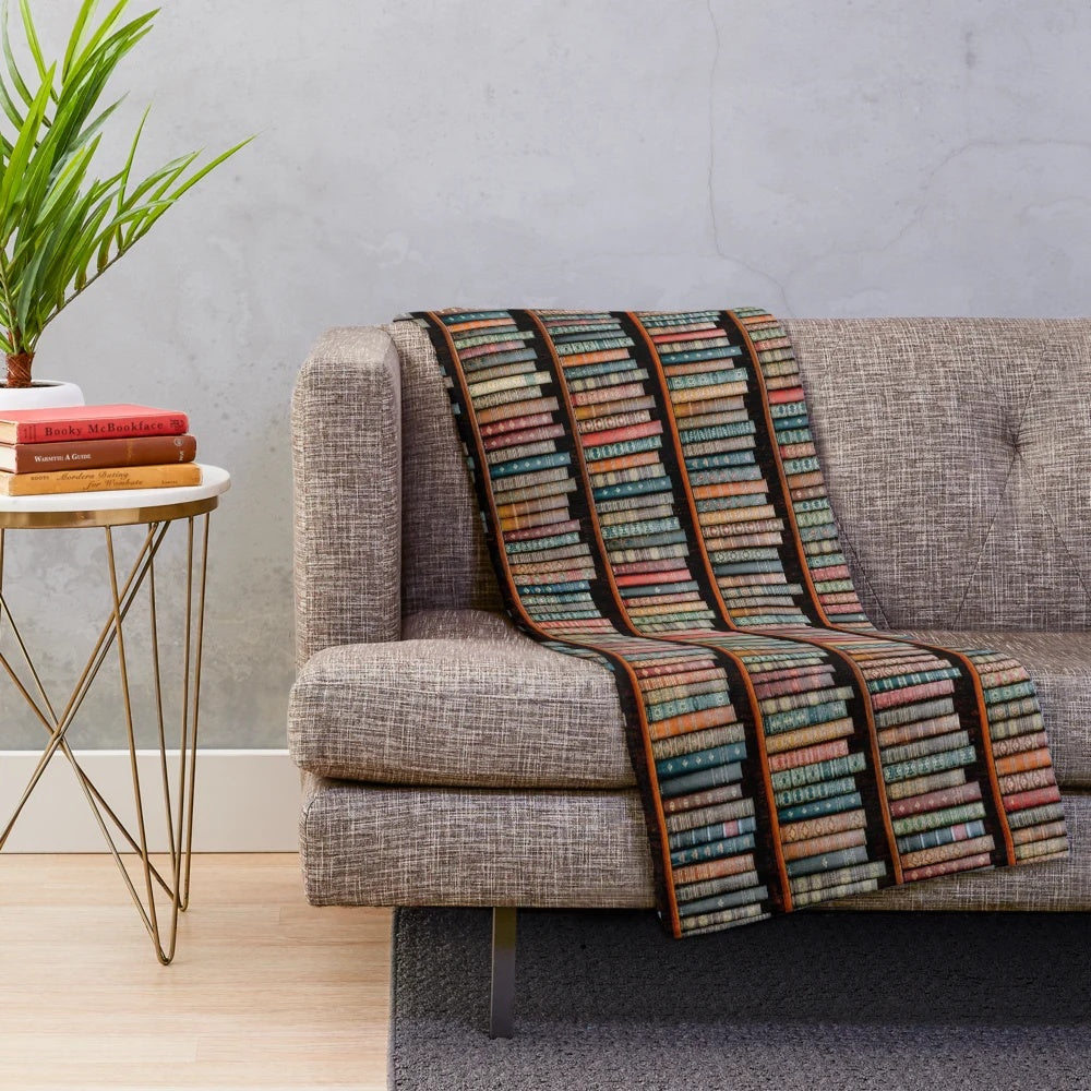 A soft, plush blanket with a library-inspired design, perfect for book lovers and reading enthusiasts.