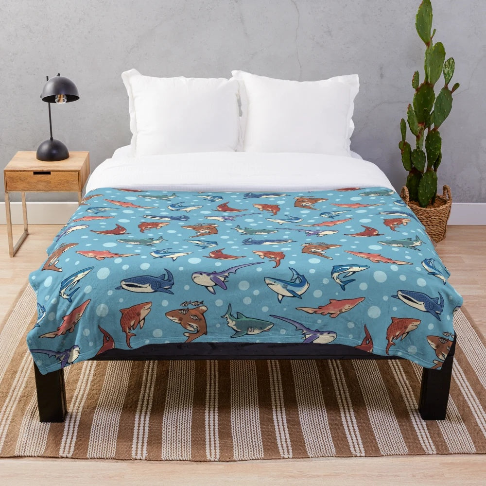 Light blue plush blanket with various shark species pattern