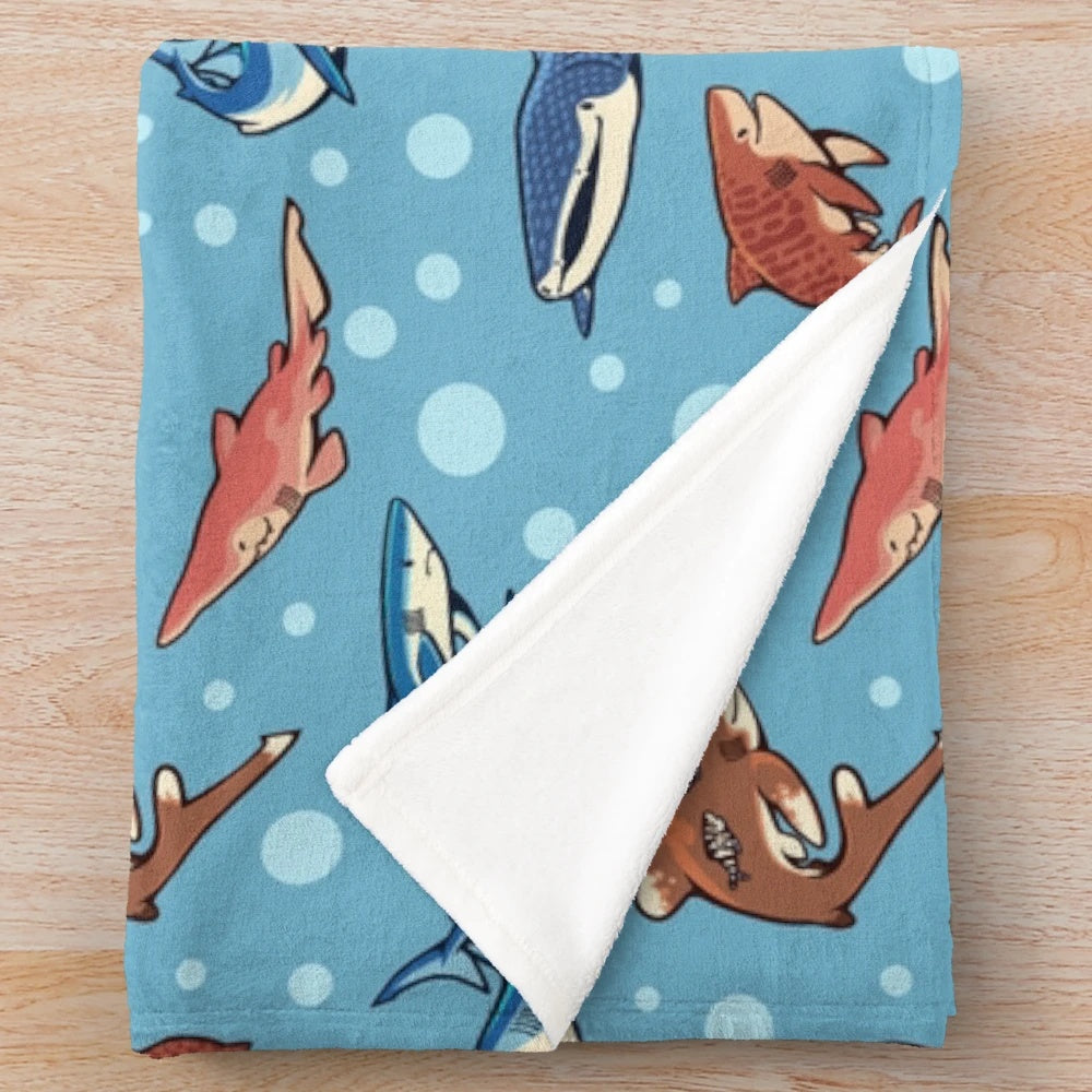 Light blue plush blanket with various shark species pattern