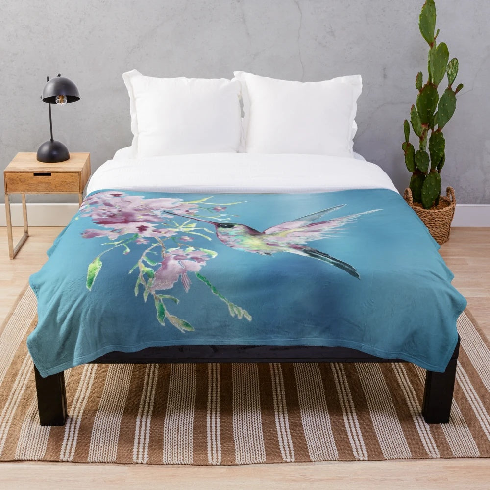 Lilac-colored plush blanket with a watercolor hummingbird design