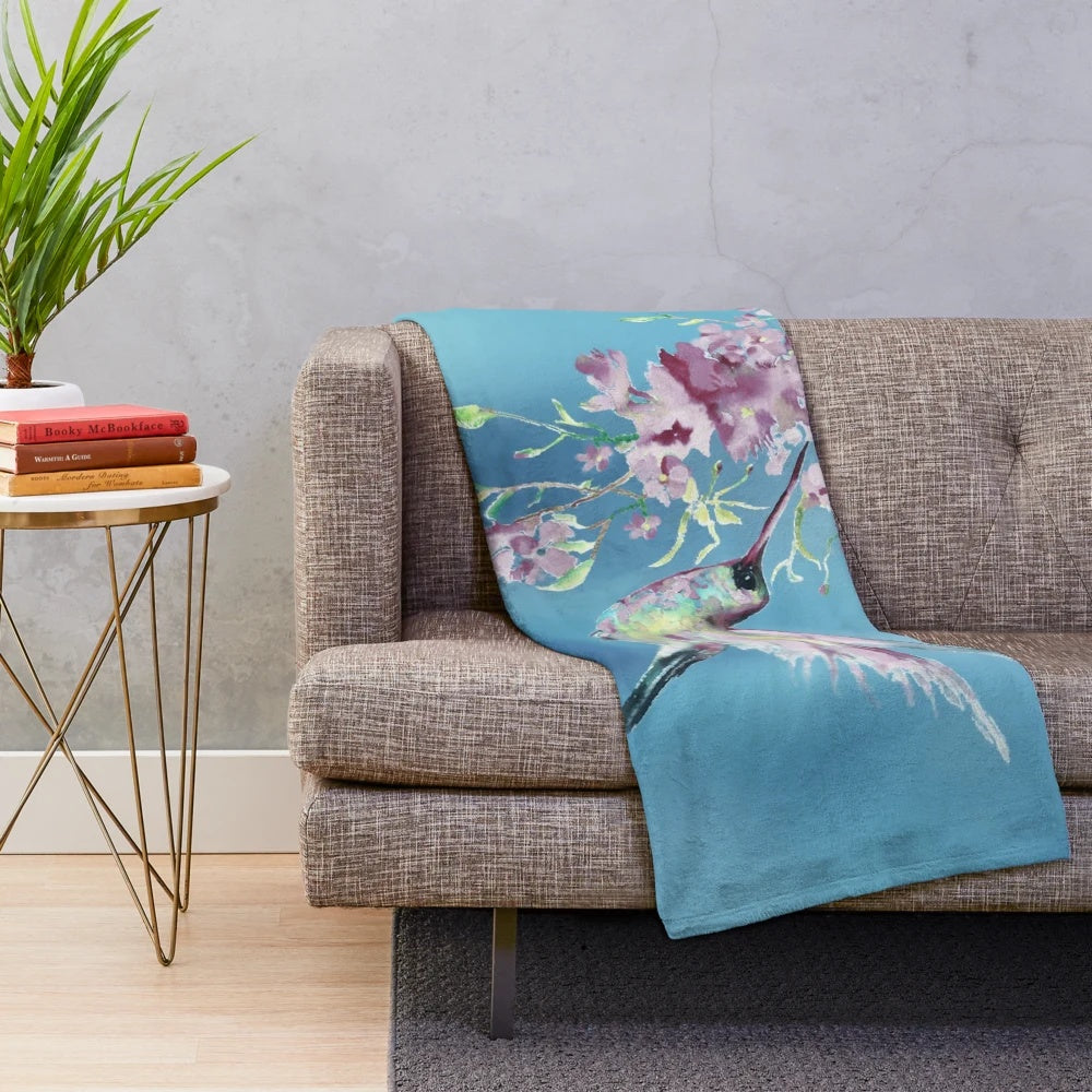 Lilac-colored plush blanket with a watercolor hummingbird design