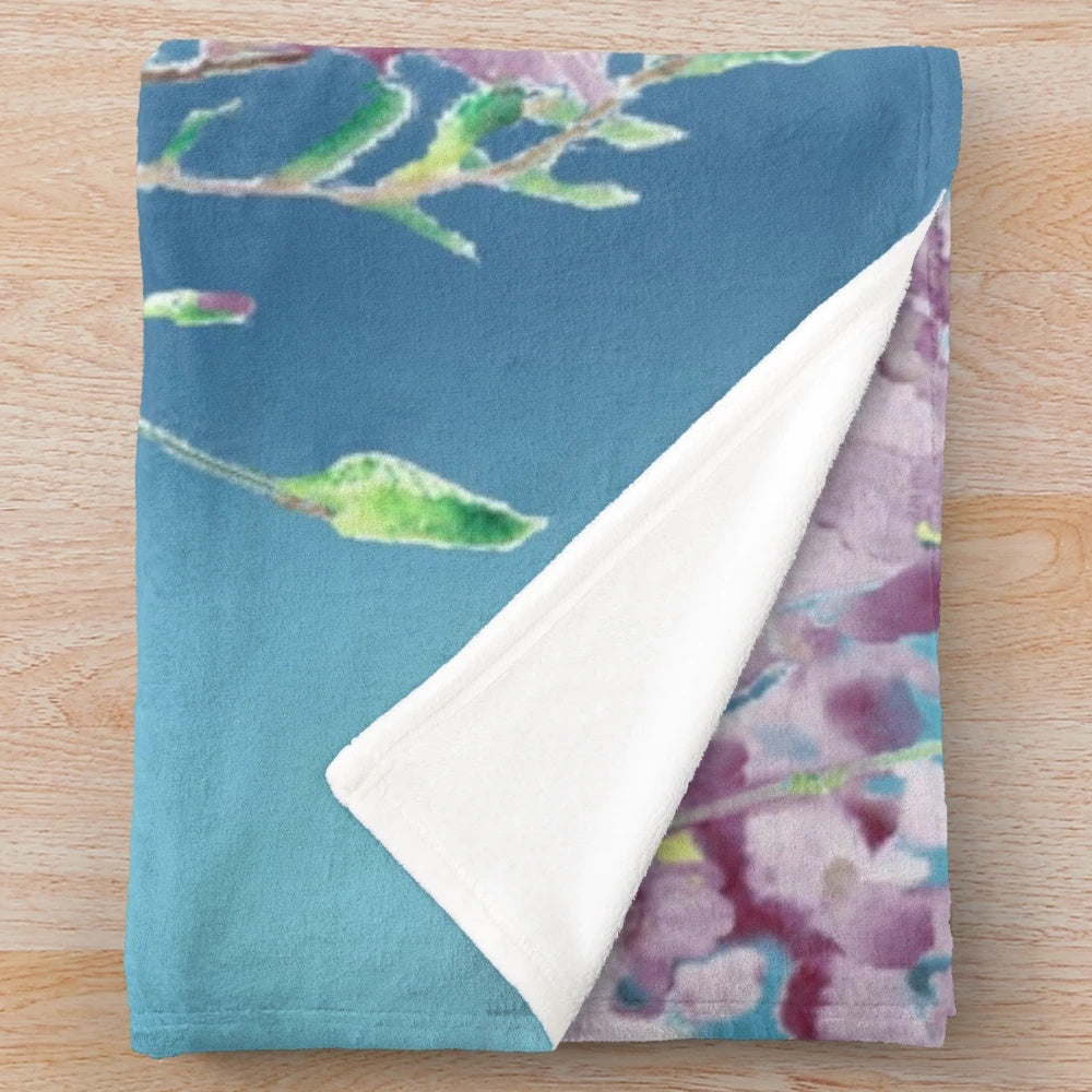 Lilac-colored plush blanket with a watercolor hummingbird design