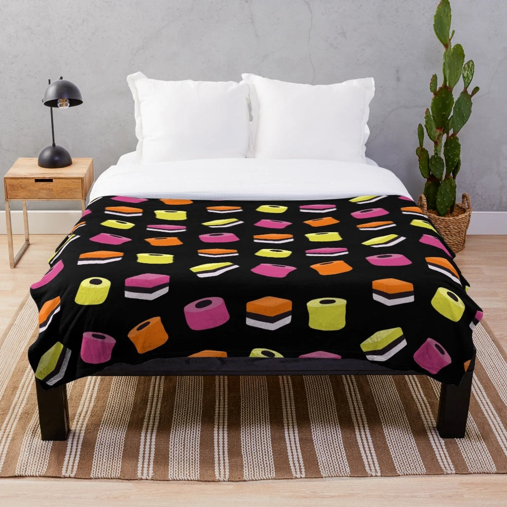 Liquorice allsorts plush blanket with multi-colored candies design