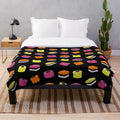 Liquorice allsorts plush blanket with multi-colored candies design