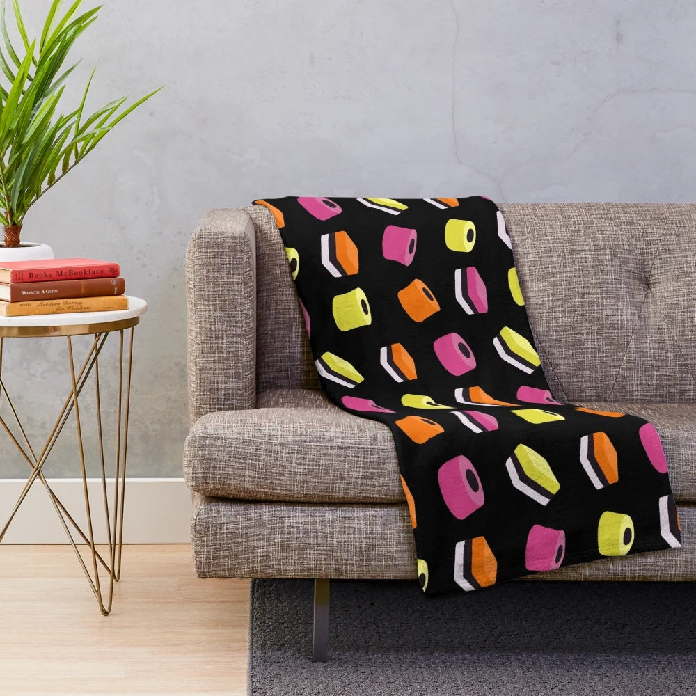 Liquorice allsorts plush blanket with multi-colored candies design
