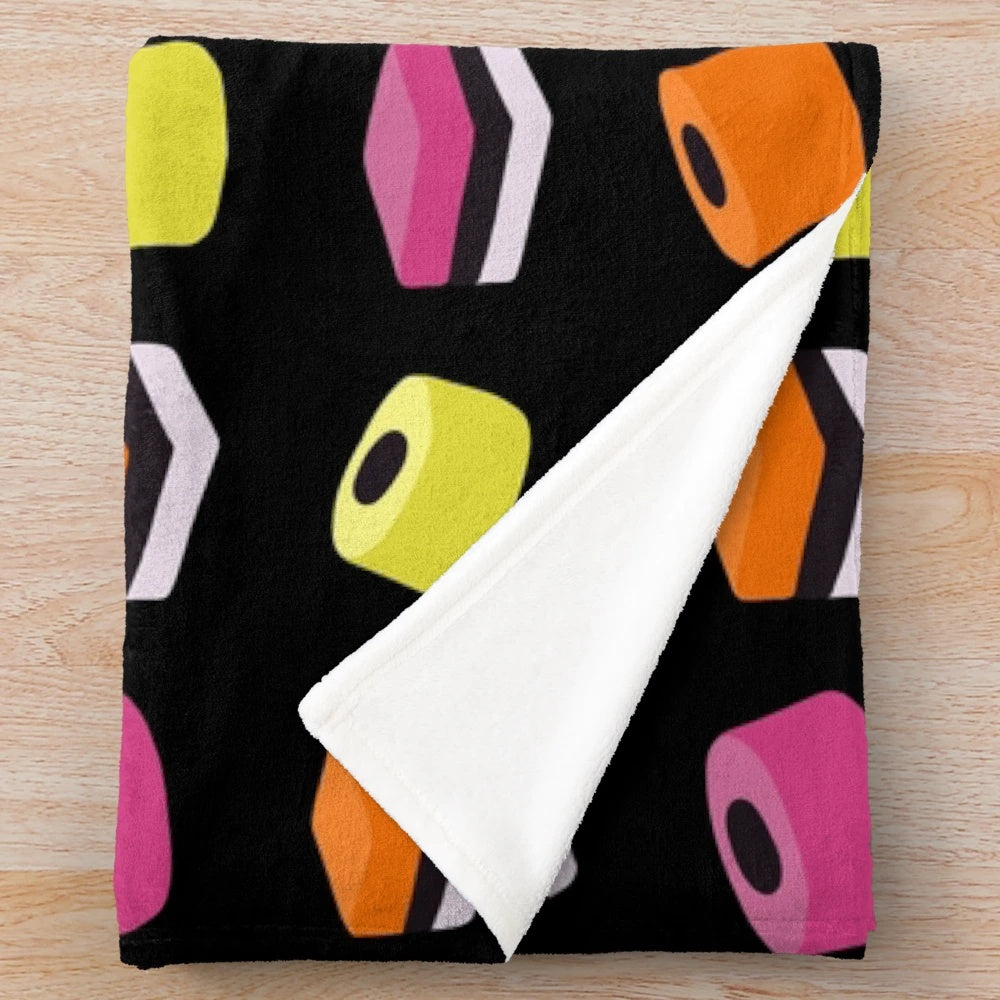 Liquorice allsorts plush blanket with multi-colored candies design