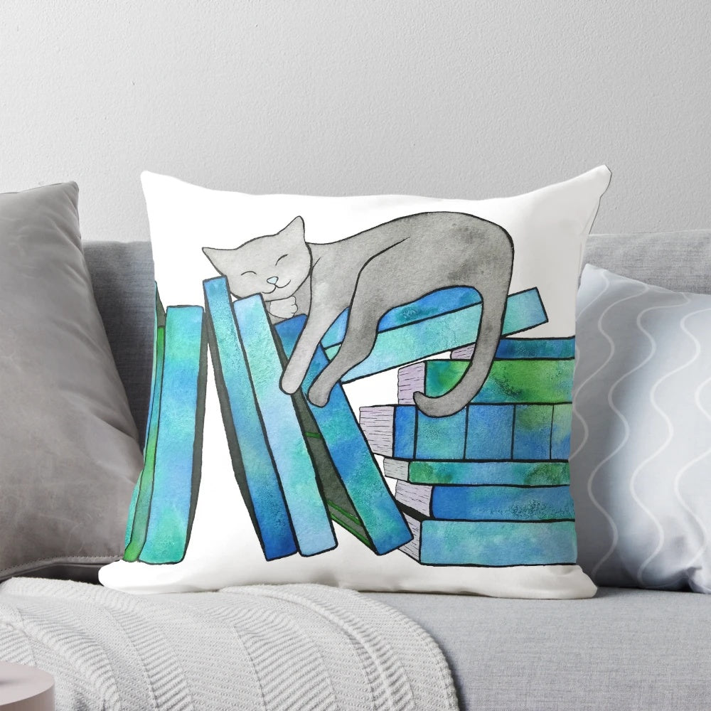 Blue Pillow with book and cat graphics, perfect for literary naps and bookworm snuggles