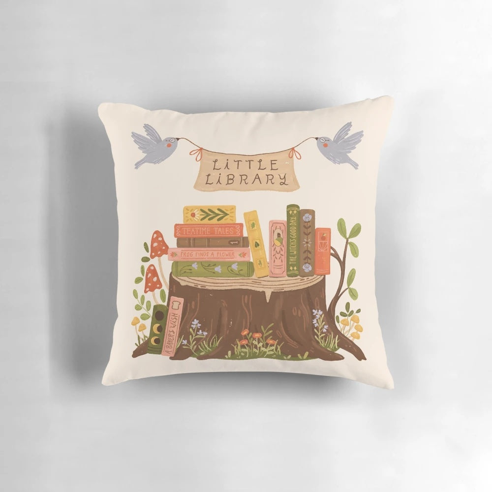 A plush, book-themed pillow with a charming "Little Library" design, perfect for book lovers and readers.