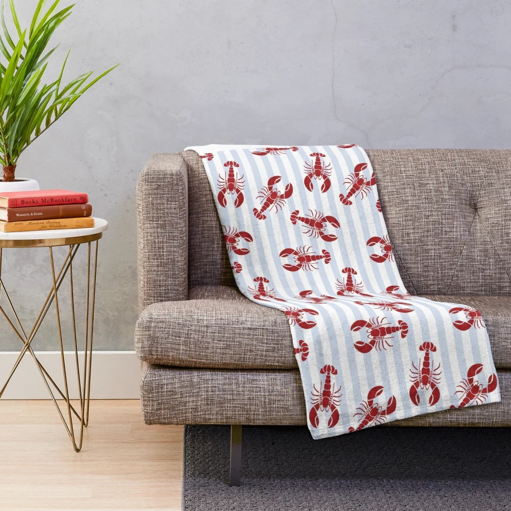 Soft and plush lobster-themed blanket in a blue and white striped design