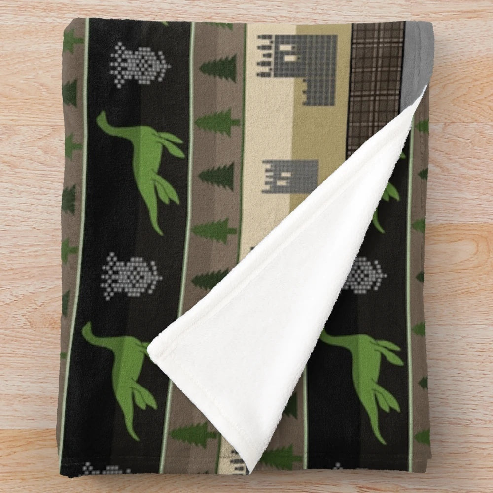 Loch Ness Fair Isle plush blanket featuring a mythical creature design